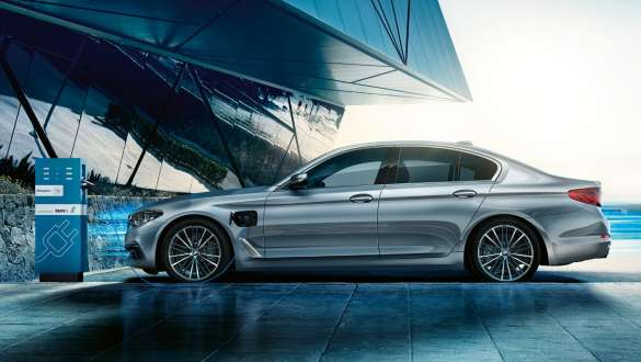 Charging BMW 530e Sedan Charging BMW 530e Sedan Glacier Silver metallic side view