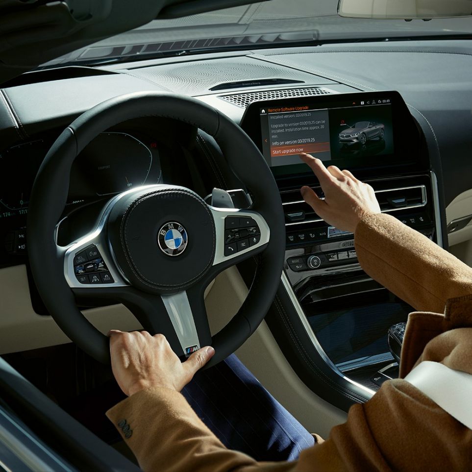 BMW M850i xDrive, driver operating BMW Live Cockpit Professional by touch control. BMW M850i xDrive, driver operating BMW Live Cockpit Professional by touch control.
