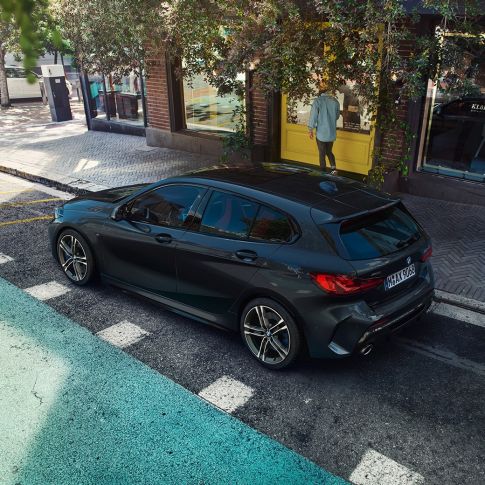 BMW M135i xDrive, parking. BMW M135i xDrive in Black Sapphire metallic parking, bird’s eye view of the side.
