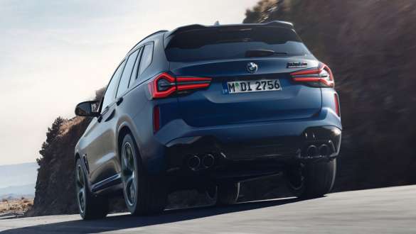 M xDrive BMW X3 M Competition F97 LCI Facelift 2021 BMW X3 M Competition F97 LCI Facelift 2021 Frozen Marina Bay Blue metallic driving rear view low-angle shot M xDrive