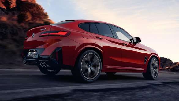 M xDrive BMW X4 M F98 LCI Facelift 2021 BMW X4 M F98 LCI Facelift 2021 M xDrive three-quarter rear view driving on the road