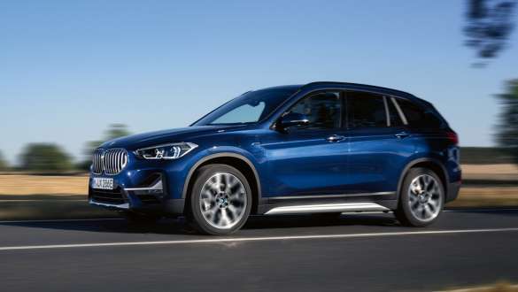 Plug-in hybrid BMW X1 xDrive25e F48 LCI three-quarter side view driving Plug-in hybrid BMW X1 xDrive25e F48 LCI three-quarter side view driving on the street