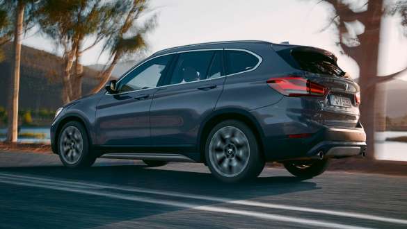 BMW X1 F48 three-quarter rear view BMW X1 F48 LCI three-quarter rear view driving in front of mountain scenery