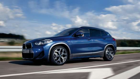 Plug-in hybrid BMW X2 xDrive25e F39 three-quarter side view driving Plug-in hybrid BMW X2 xDrive25e F39 three-quarter side view driving on the street