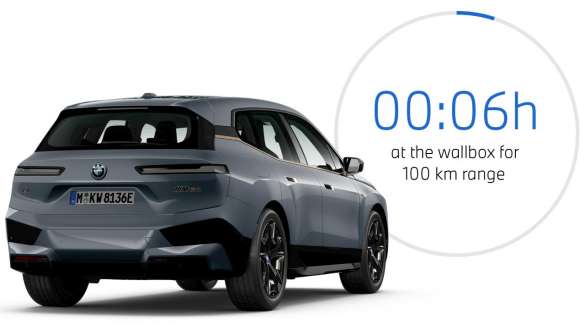 BMW iX M60 i20 2022 electric SUV BMW Individual Storm Bay metallic three-quarter rear view with charging time graphic