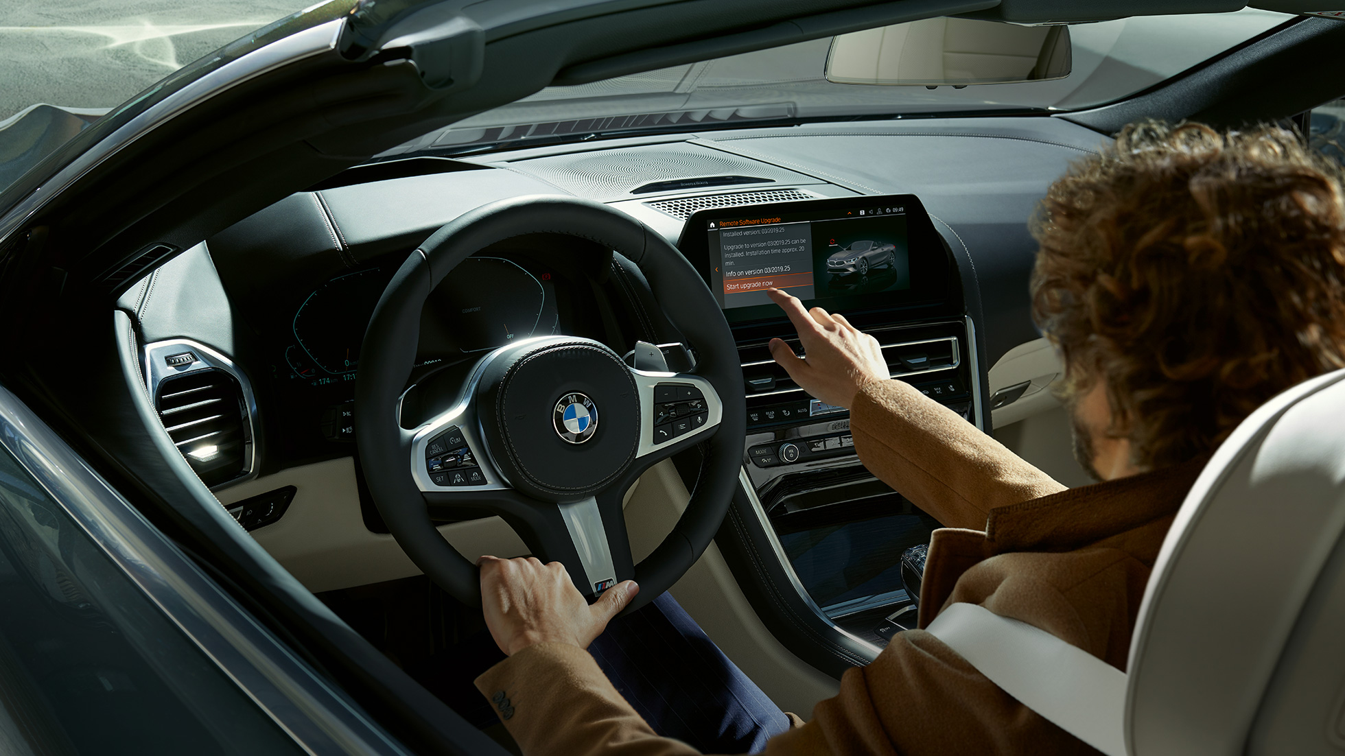 BMW M850i xDrive, driver operating BMW Live Cockpit Professional by touch control. BMW M850i xDrive, driver operating BMW Live Cockpit Professional by touch control.