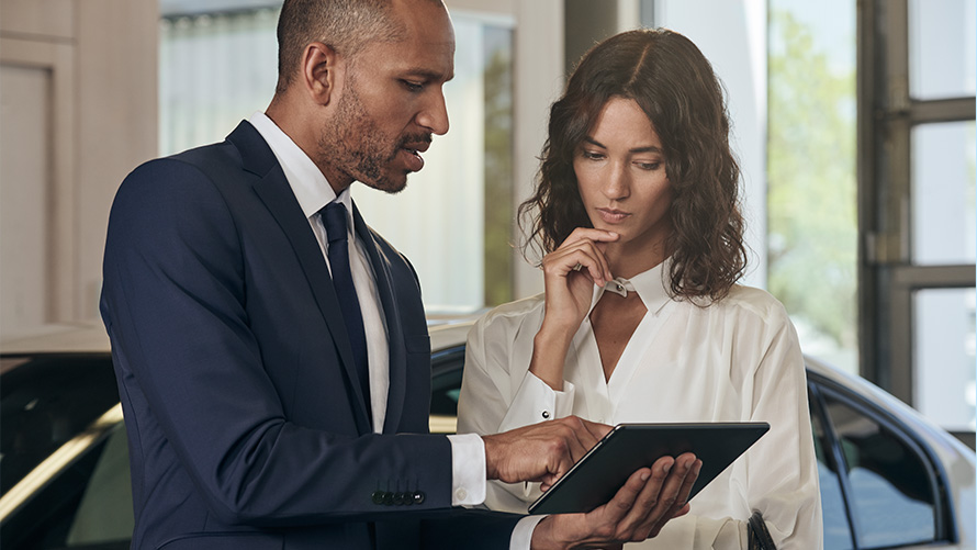 BMW service employee consults customer