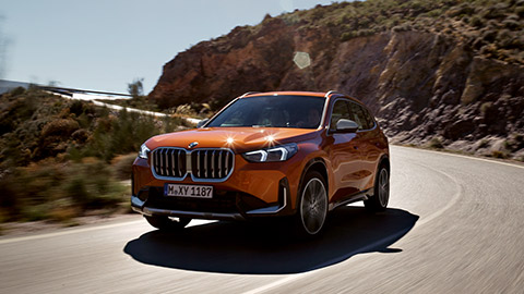 BMW X1 U11 three-quarter front view driving on the street  BMW X Series BMW X1 U11 three-quarter front view driving on the street