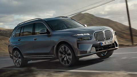 BMW X7 G07 three-quarter front view driving on the road BMW X Series BMW X7 G07 three-quarter front view driving on the road