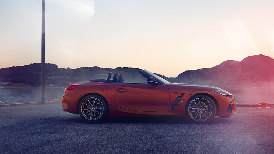 Side view orange BMW Z4 First Edition Side view orange BMW Z4 First Edition in front of mountain view