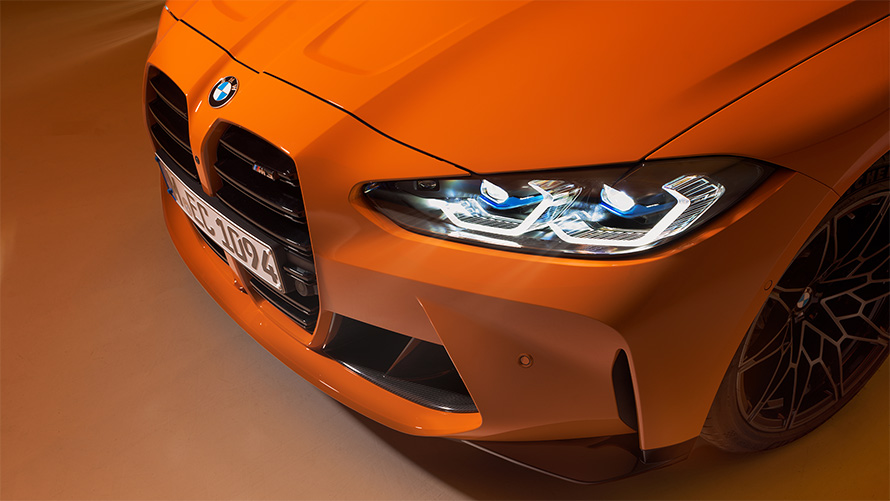 BMW M4 Competition Coupé G82 2021 BMW Individual Fire Orange standing three-quarter front view close-up with top view