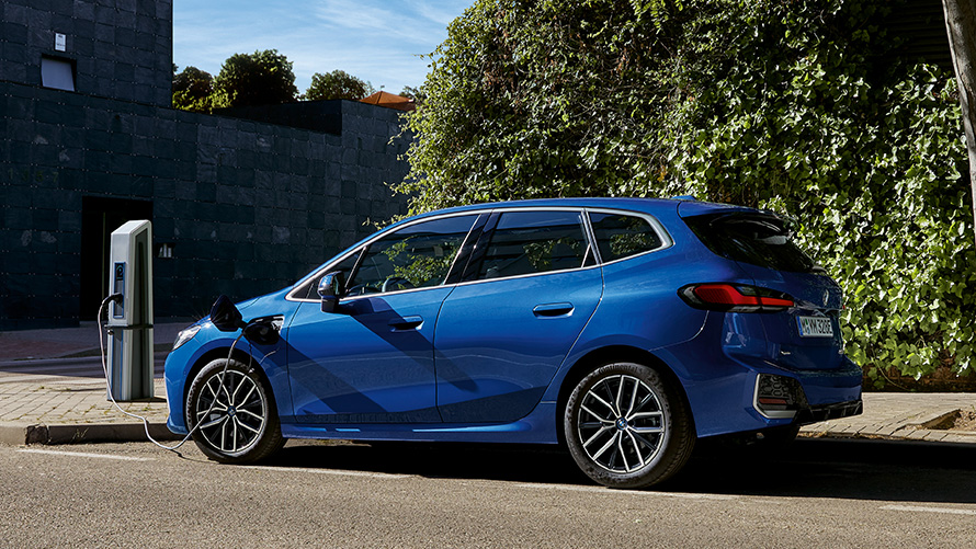 BMW 2 Series Active Tourer Plug-in hybrid 2021 U06 side view at charging station